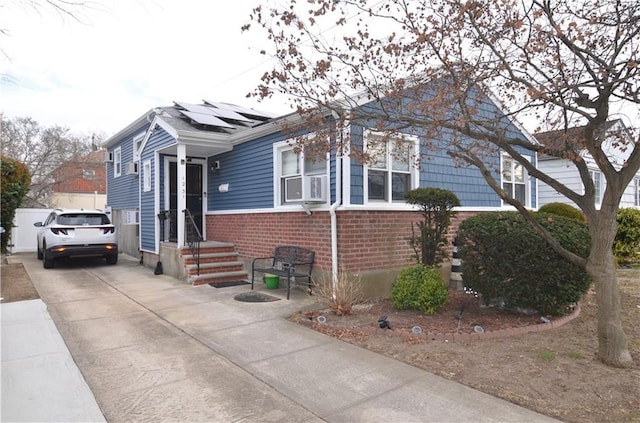 view of front of property featuring solar panels