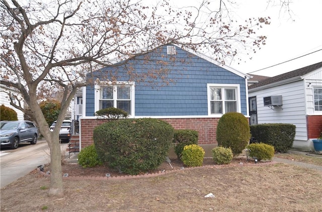 view of property exterior featuring a wall mounted air conditioner