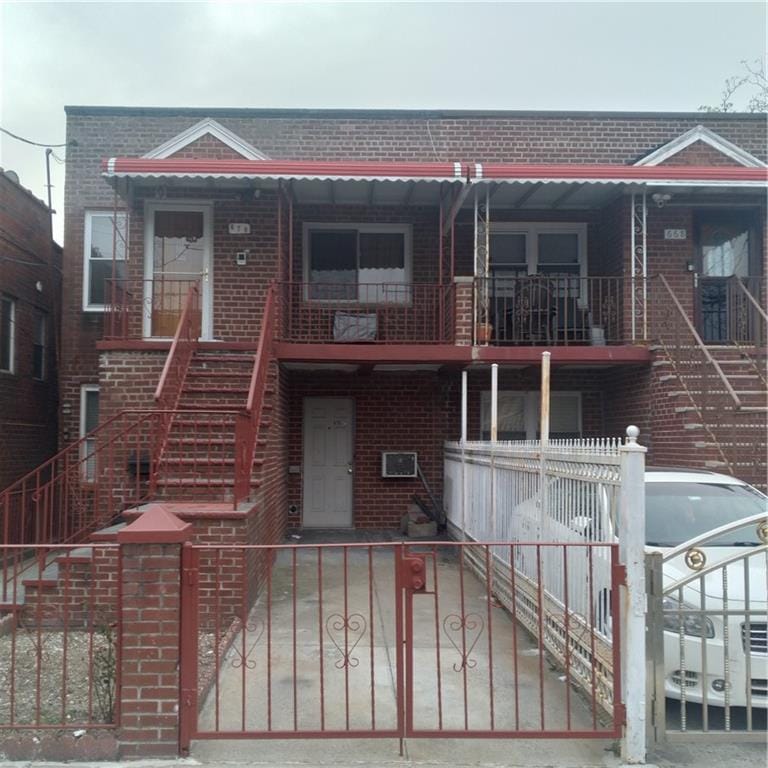 view of front of home with brick siding and stairway