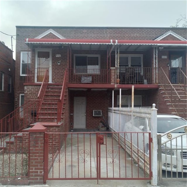 view of front of house featuring brick siding and stairs