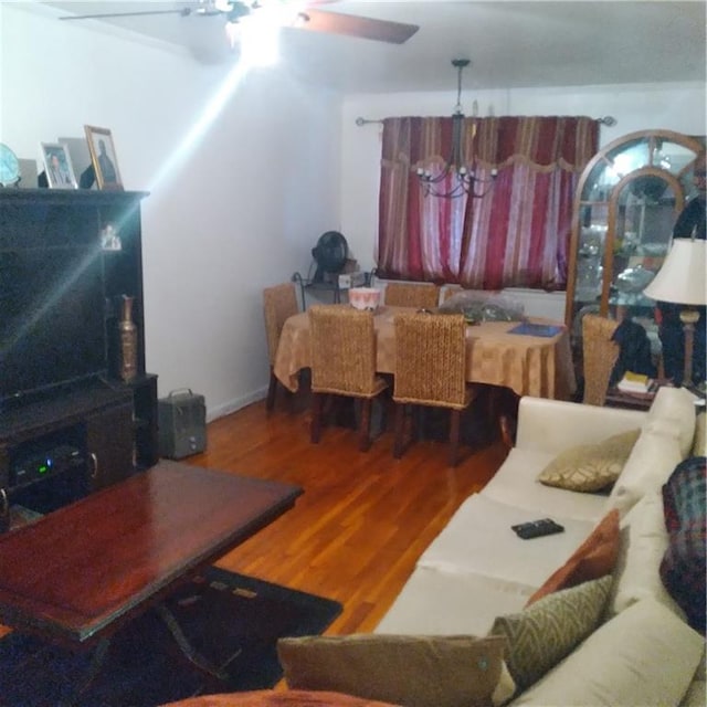 living room with hardwood / wood-style flooring and a notable chandelier