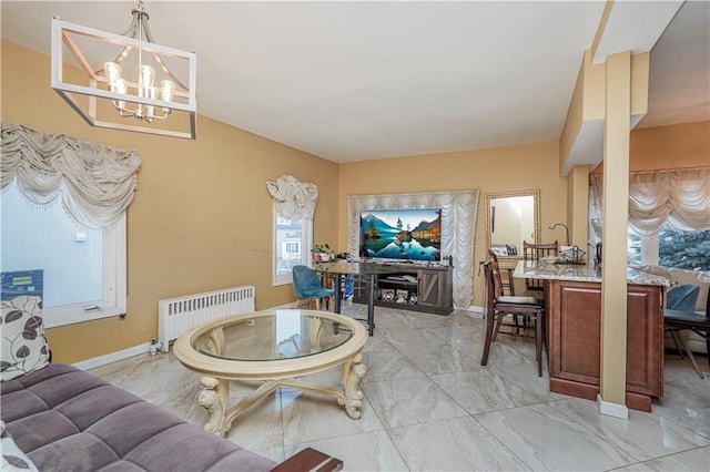 living room featuring an inviting chandelier and radiator