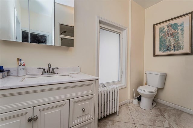 bathroom featuring vanity, radiator heating unit, and toilet