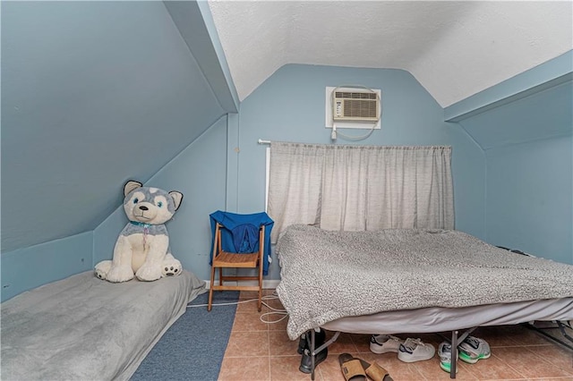 tiled bedroom with vaulted ceiling, an AC wall unit, and a textured ceiling