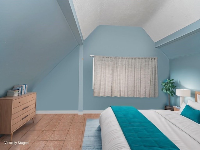 bedroom with light tile patterned flooring, lofted ceiling, and a textured ceiling