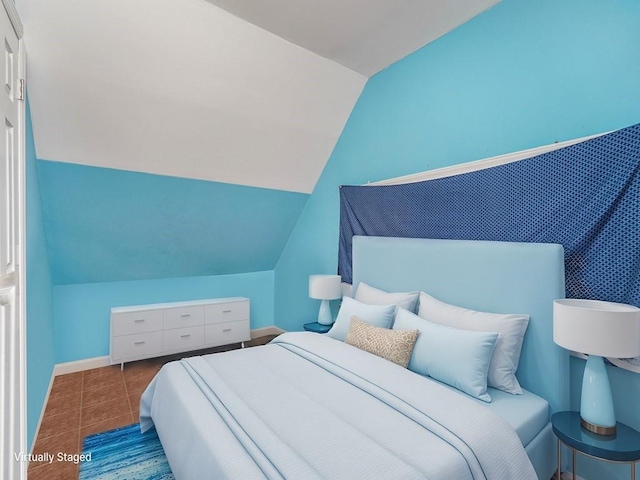 bedroom with lofted ceiling and tile patterned floors