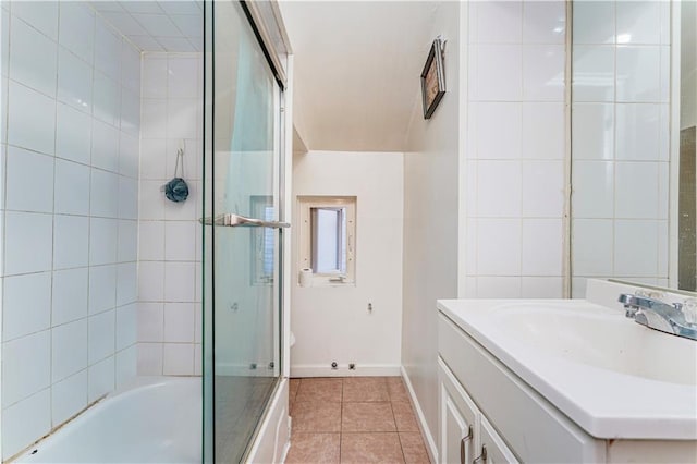 bathroom with enclosed tub / shower combo, tile patterned floors, and vanity