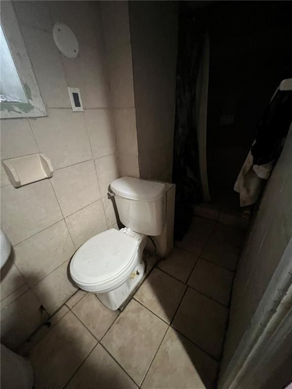 bathroom with toilet and tile patterned flooring