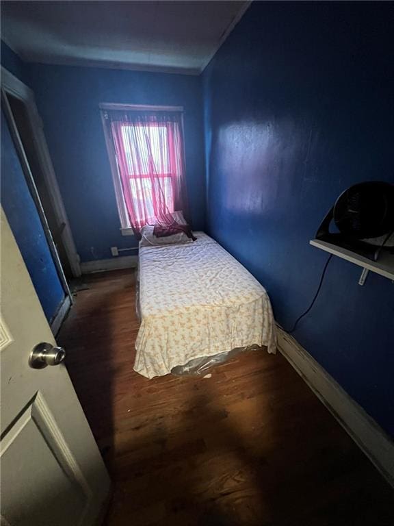 bedroom with dark hardwood / wood-style flooring