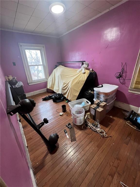 bedroom with hardwood / wood-style flooring and ornamental molding