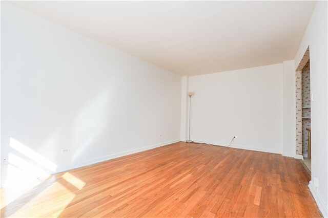 spare room with wood-type flooring