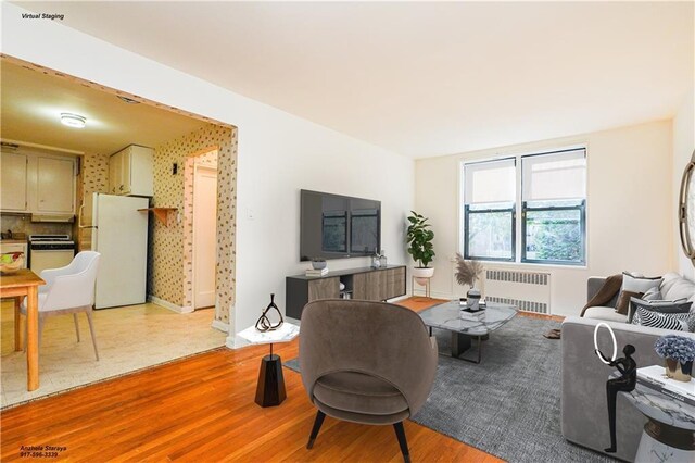 living room featuring light hardwood / wood-style floors and radiator heating unit