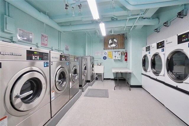 clothes washing area with washer and clothes dryer