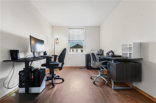 home office featuring baseboards and wood finished floors