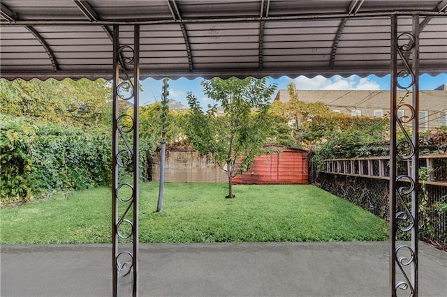 view of yard featuring fence and a patio area