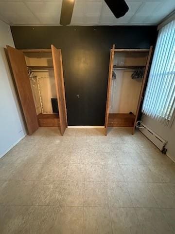 unfurnished bedroom featuring baseboard heating and a closet