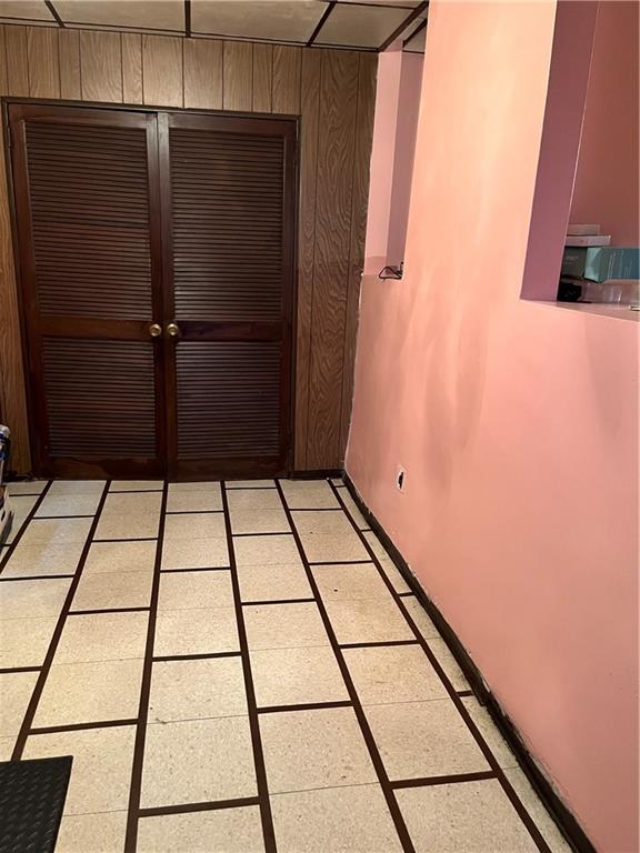 interior space with a closet and wooden walls