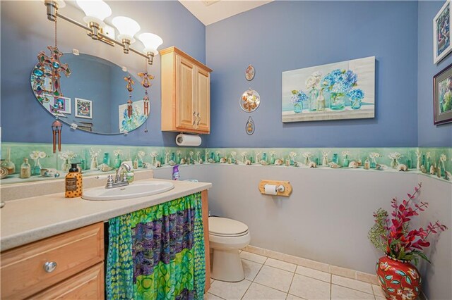 bathroom featuring toilet, tile patterned floors, and vanity