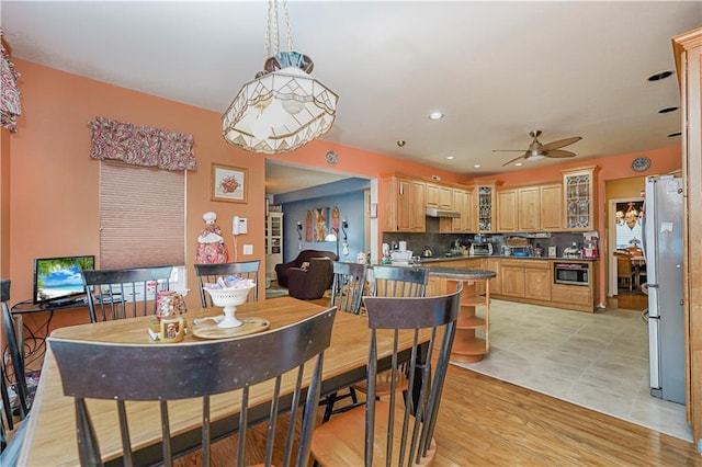 dining room featuring ceiling fan and light hardwood / wood-style flooring