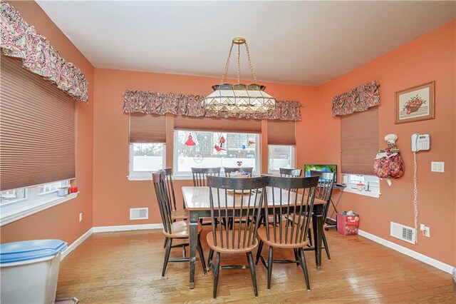 dining space with light wood-type flooring