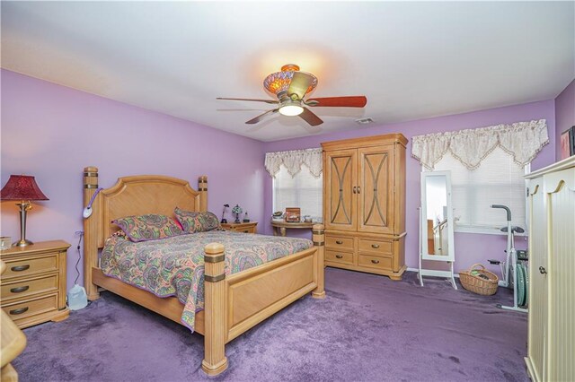 bedroom featuring ceiling fan, carpet floors, and multiple windows