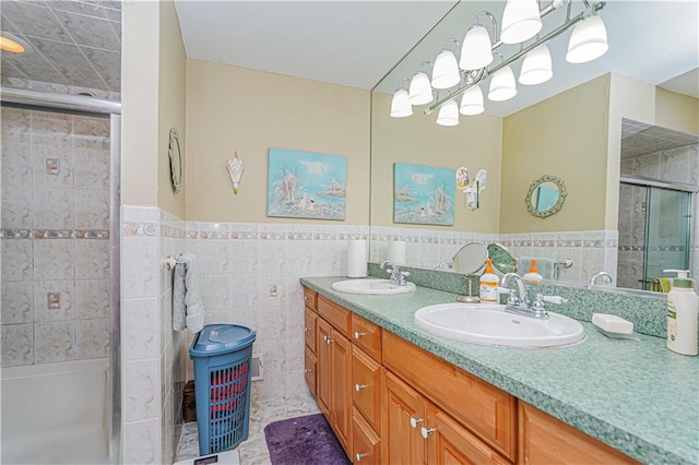 bathroom featuring tile patterned flooring, tile walls, walk in shower, and vanity