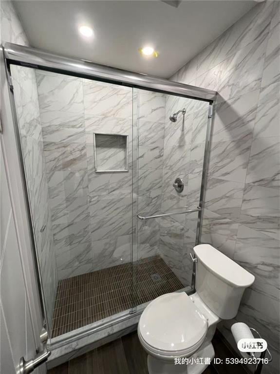 full bathroom with toilet and a stall shower