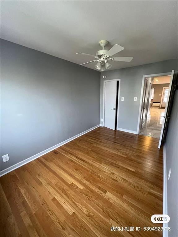 1574 E 66th St, Brooklyn, NY 11234 - unfurnished bedroom featuring wood finished floors, baseboards, a ceiling fan, and baseboard heating
