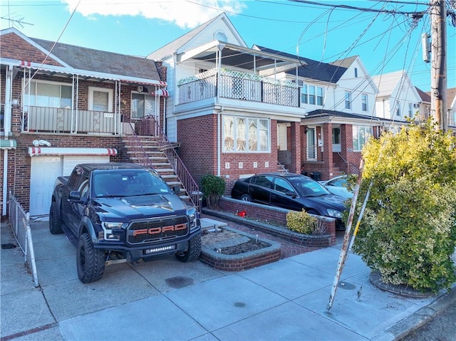 view of front facade featuring a garage and a balcony