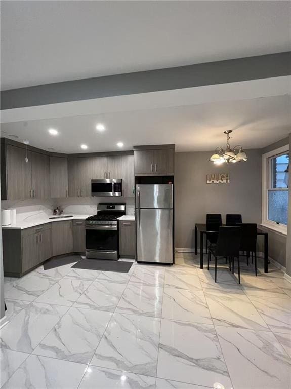 kitchen with dark brown cabinets, light countertops, recessed lighting, an inviting chandelier, and stainless steel appliances