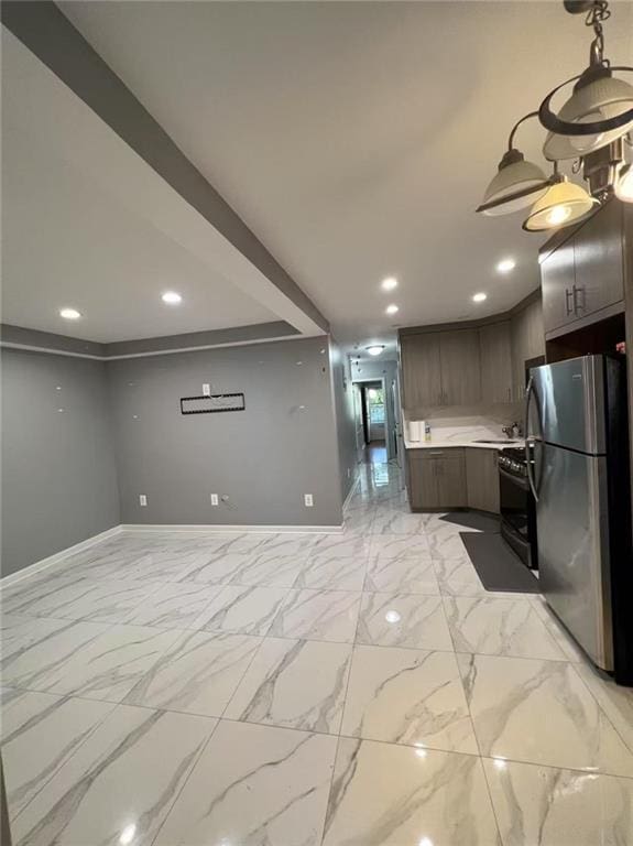 kitchen with black gas range, marble finish floor, light countertops, and freestanding refrigerator