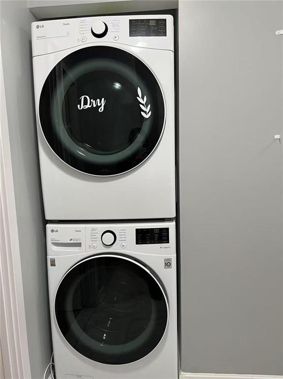 laundry room with laundry area and stacked washer and dryer