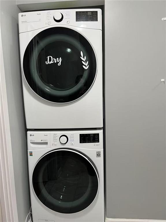 1574 E 66th St, Brooklyn, NY 11234 - washroom with stacked washer and clothes dryer