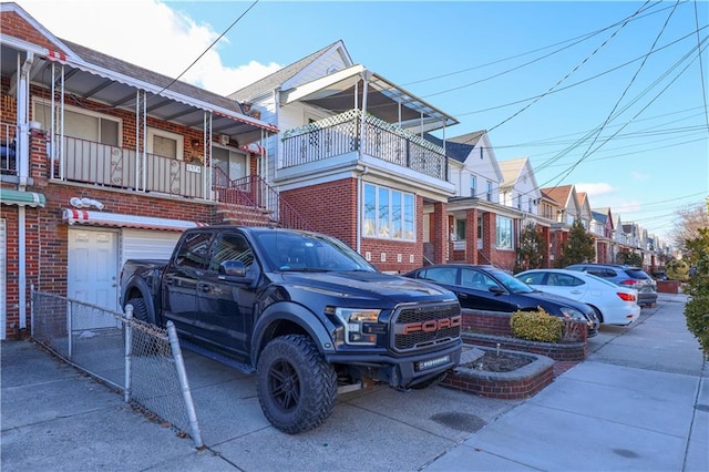 view of front of home with brick siding and uncovered parking