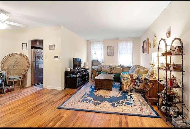 living room featuring ceiling fan and wood-type flooring