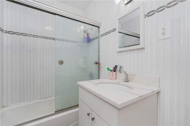 bathroom featuring enclosed tub / shower combo and vanity