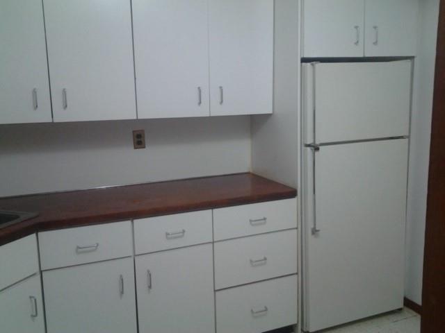 kitchen with white cabinets and white refrigerator