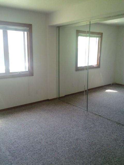 unfurnished bedroom with carpet flooring and a closet