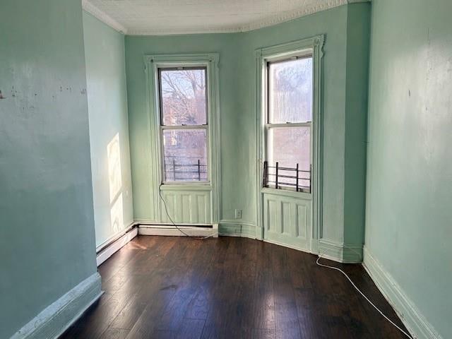 unfurnished room with dark hardwood / wood-style flooring