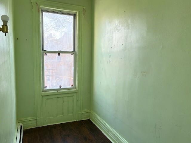 entryway featuring a baseboard heating unit and dark hardwood / wood-style floors