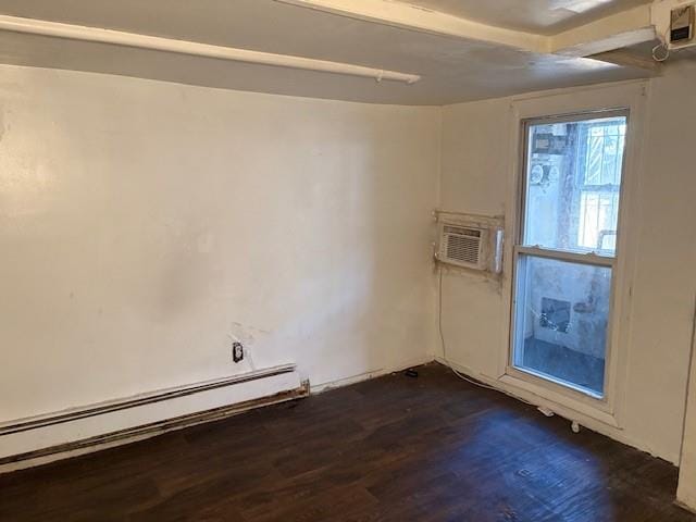 empty room featuring a wall mounted AC, dark hardwood / wood-style floors, and a baseboard radiator