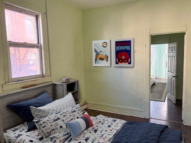 bedroom with dark wood-type flooring