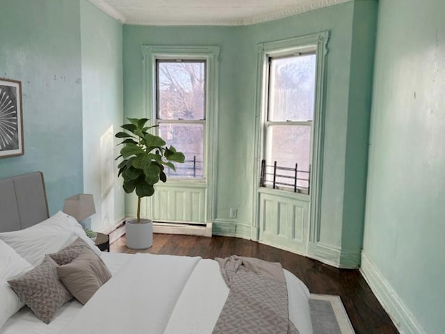 bedroom featuring dark wood-type flooring and a baseboard radiator