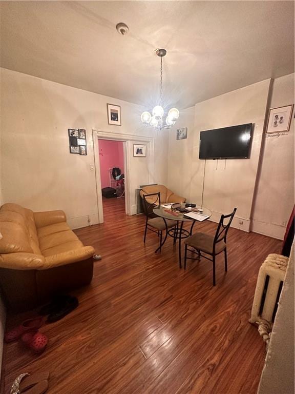 dining space featuring an inviting chandelier and dark hardwood / wood-style flooring