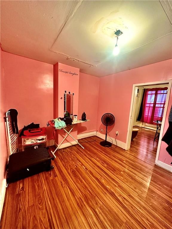 sitting room with wood-type flooring