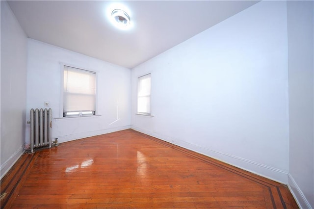1445 W 5th St, Brooklyn, NY 11204 - unfurnished room featuring baseboards, radiator heating unit, and hardwood / wood-style flooring