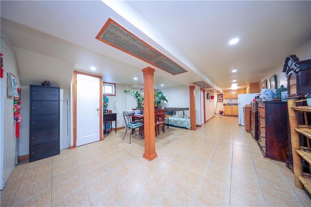 1445 W 5th St, Brooklyn, NY 11204 - below grade area with recessed lighting, freestanding refrigerator, and light tile patterned floors