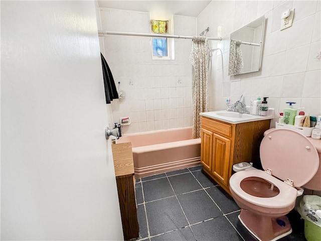 full bathroom with shower / bath combo, tile walls, tile patterned flooring, vanity, and toilet