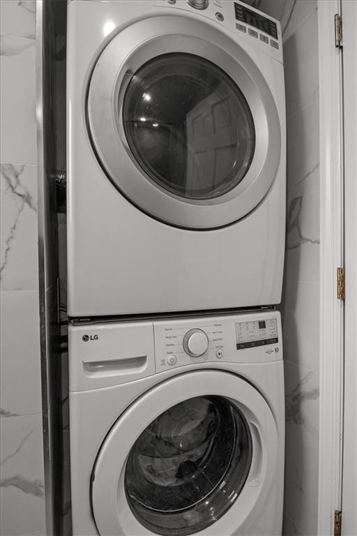 laundry room featuring stacked washer and dryer and laundry area