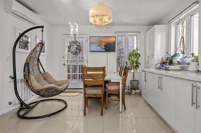 dining area featuring light tile patterned flooring, a wall mounted air conditioner, and an inviting chandelier